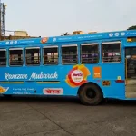 City bus wrapped with Ramzan Mubarak themed advertising featuring Switz food brand messaging in transit media format