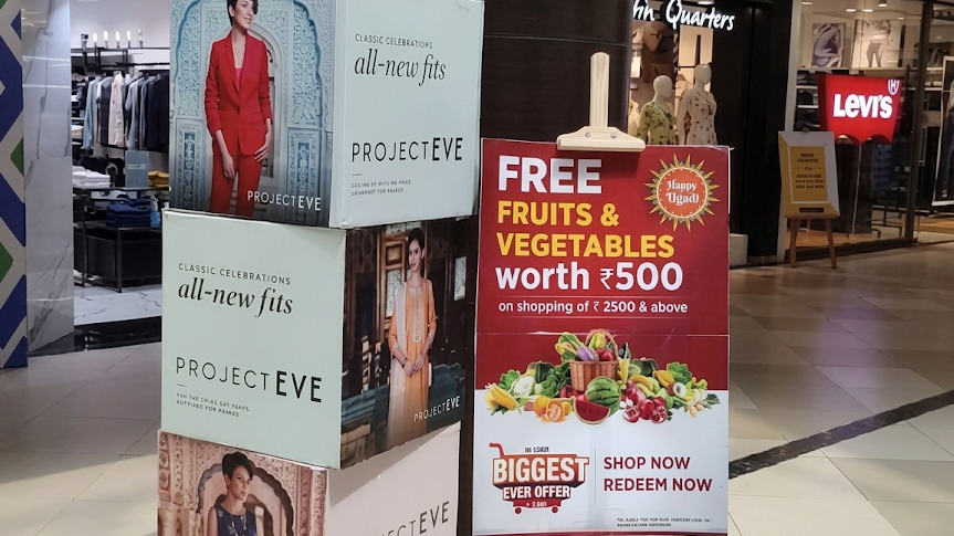 retail standee advertising and promotional kiosk inside shopping mall walkway