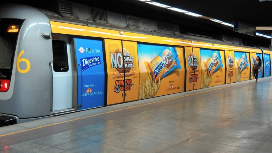 Metro train wrapped with digestive biscuit brand advertising highlighting no added sugar and healthy snack positioning