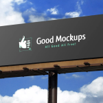 Large outdoor billboard mockup displaying “Good Mockups – All Good All Free!” against a bright blue sky with clouds
