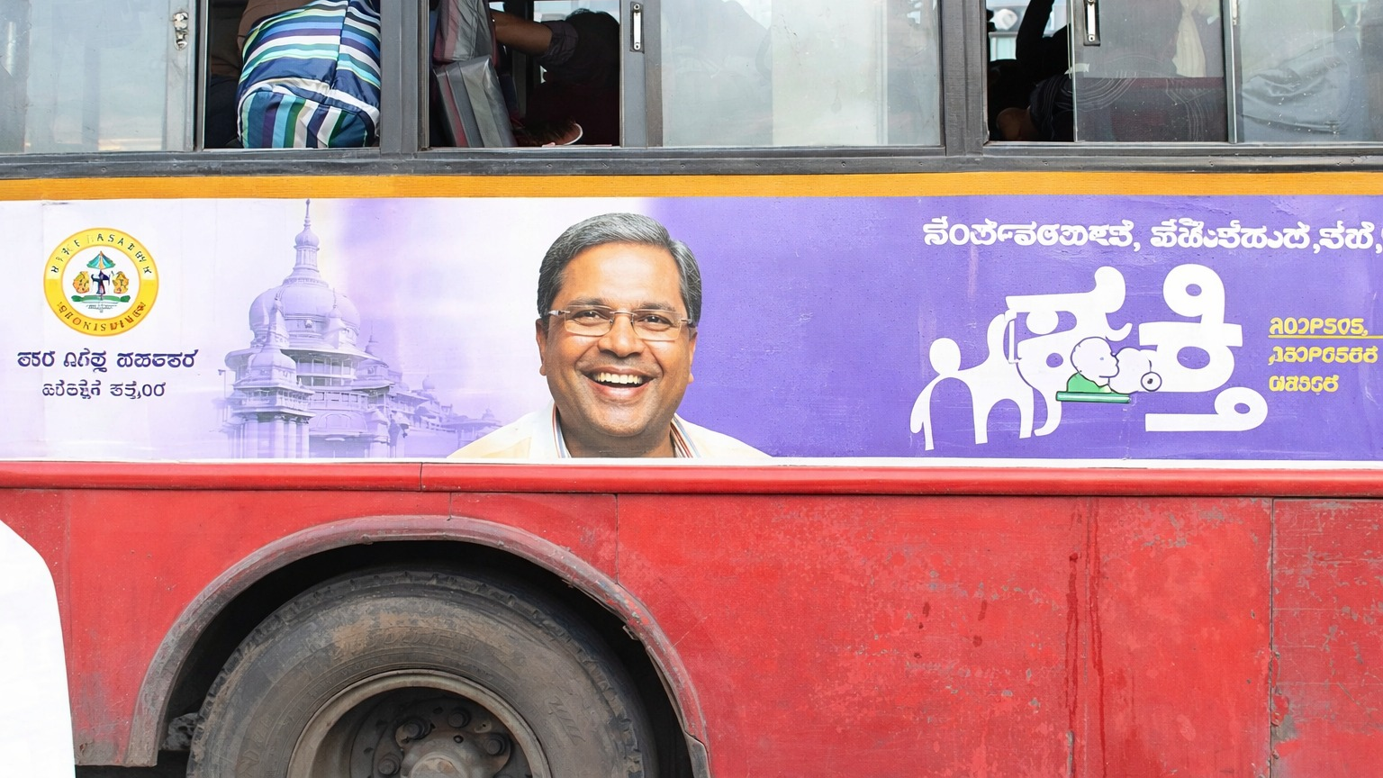 Use the bus political campaign image to highlight localized political outreach and strong visual impact at the street level, even though it is not train-based.
