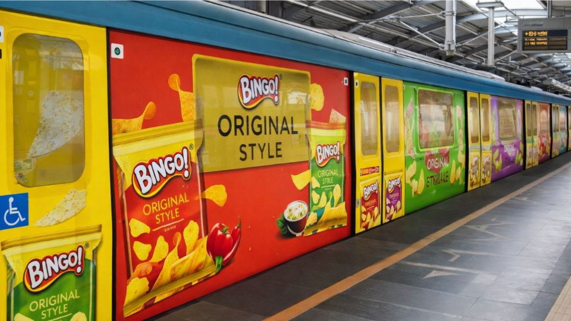 A metro train parked at a station completely wrapped in vibrant red, yellow, and green Bingo! chips advertisements, covering the doors and exterior panels.