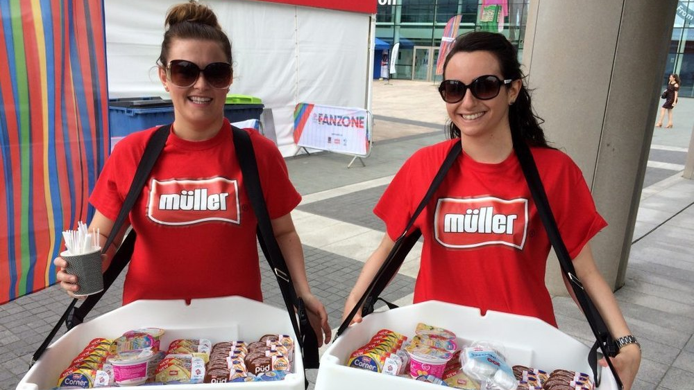 Experiential marketing with product sampling promotion activity Brand promoters distributing food samples during on-ground marketing activation event