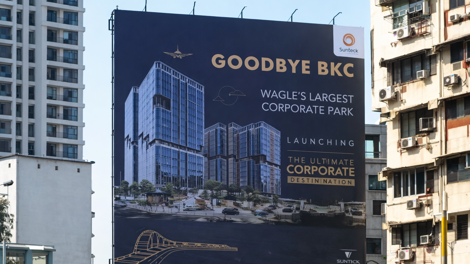 Large outdoor billboard promoting corporate park real estate project with modern building visuals in cityscape