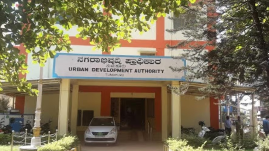 Urban Development Authority office building entrance with signage and parked vehicle