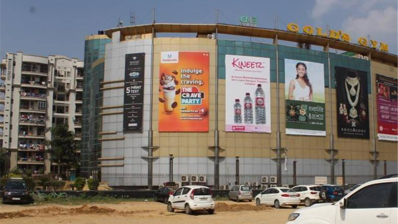 Mall facade advertising featuring multiple brand campaigns in urban retail space Shopping mall exterior with multiple large format brand advertisements displayed on building facade