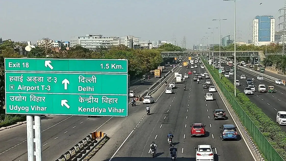 Delhi highway road signage indicating airport and city directions Highway directional signage showing routes to Delhi airport T3 Udyog Vihar and Kendriya Vihar with heavy traffic