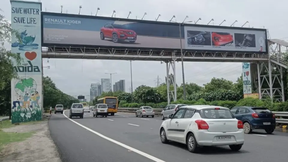 Renault Kiger large format highway billboard advertising campaign Highway gantry billboard promoting Renault Kiger car with vehicles driving on expressway in urban setting