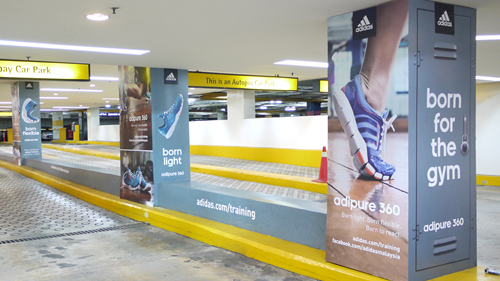 parking lot branding with pillar ads and wall graphics targeting daily commuters