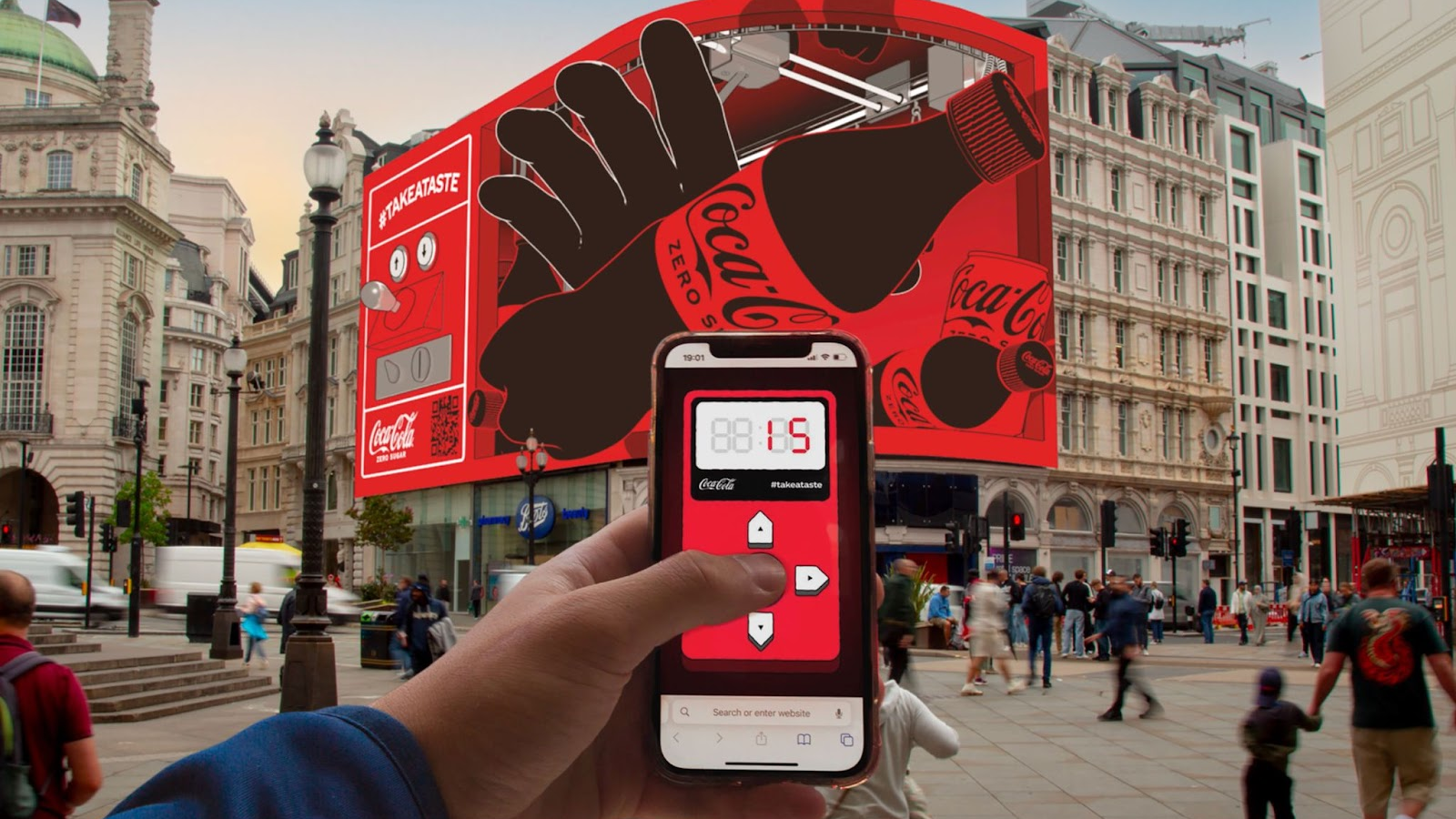 Gamified DOOH: A massive digital billboard for Coca-Cola Zero Sugar in a busy city square (Piccadilly Circus) is synced with a user's smartphone, turning the mobile device into a controller for an interactive on-screen experience.