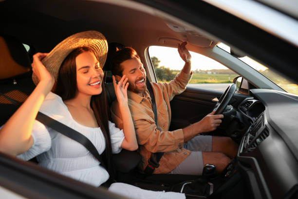 A couple enjoying music while driving in a car during a road trip, representing radio advertising in India through in-car entertainment and FM listening experiences. The image highlights how radio ads connect with commuters and travelers during everyday journeys and long drives.