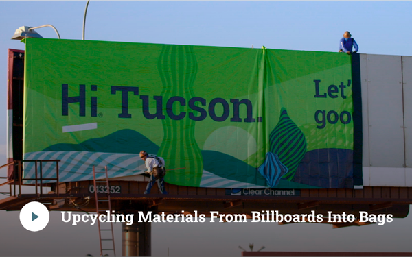 A sustainable outdoor advertising billboard being installed with recyclable banner material in an urban area, accompanied by the message “Upcycling Materials From Billboards Into Bags.” The image highlights eco-friendly outdoor advertising practices where billboard materials are repurposed into reusable products to reduce waste and support sustainable brand initiatives.