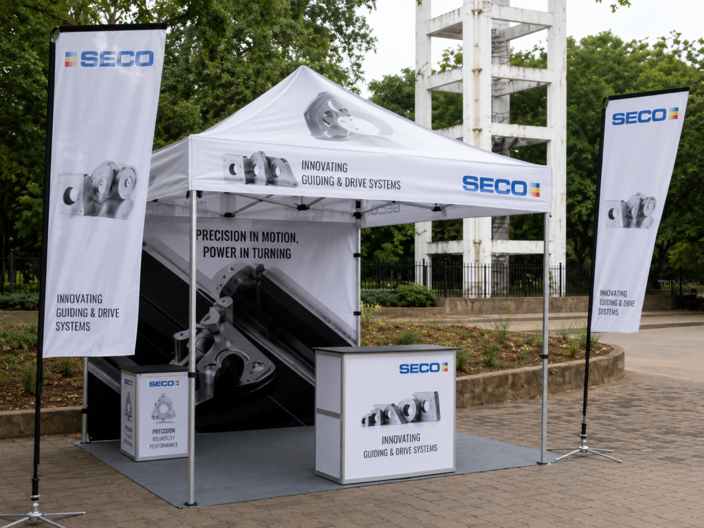 A branded society activation setup by SECO features a promotional canopy stall with banners, product visuals, and display counters installed in an outdoor residential or community space. The activation combines experiential marketing, on-ground engagement, and product showcasing to create direct interaction with residents and visitors in a high-footfall society environment.