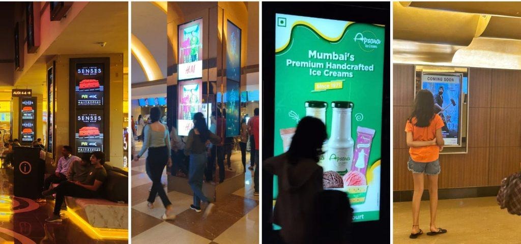 A series of digital advertising screens placed across a cinema lobby display movie promotions and brand advertisements. Positioned along high footfall walkways, these digital displays engage moviegoers before screenings and create repeated visibility throughout the cinema experience.